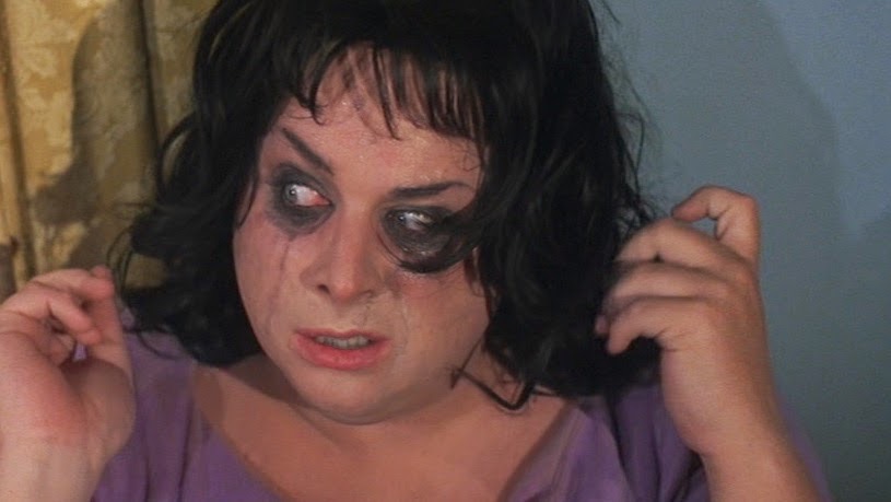 A woman with runny, tearstained eyeliner.