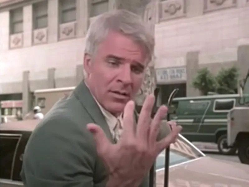 Steve Martin looks at his hand while doing that thing with his face that he thinks is feminine, which is just a furrowed brow.