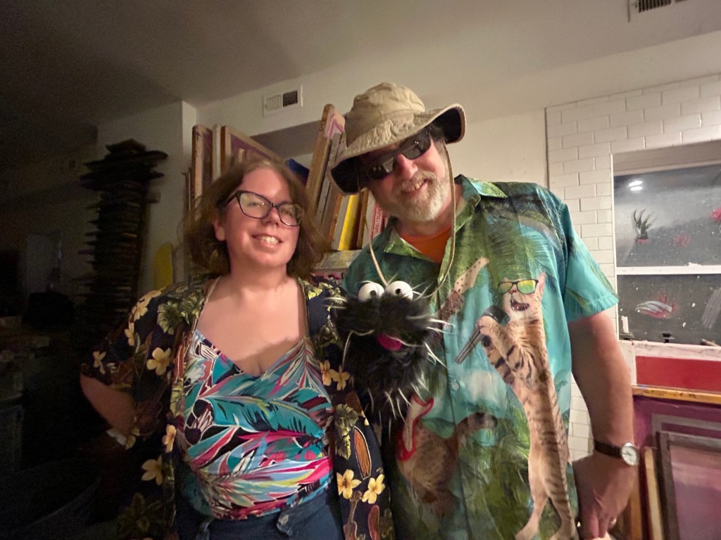 Mary, Dennis, and Reggie in their beachwear best. There are cats in a band on Dennis's tropical shirt. They are such cuties.
