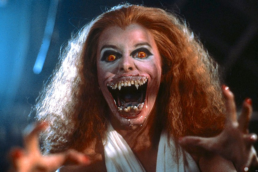 A redheaded woman is a monster. Her eyes are slightly too big and orange and red, and her mouth is too large and full of broken, jagged teeth and fangs. It's truly awful.