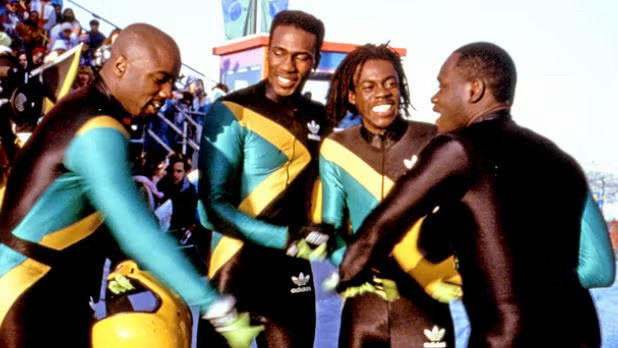 Four men in tight, Adidas-brand outfits look happy together