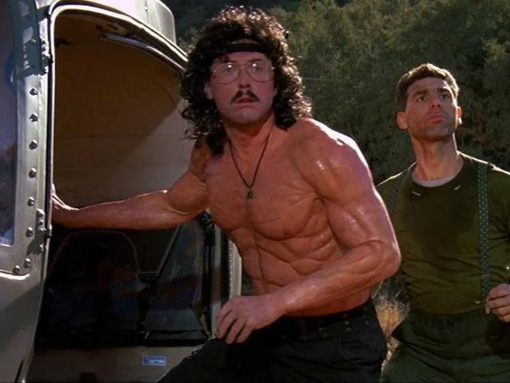 Weird Al dressed as Rambo, including fake muscles
