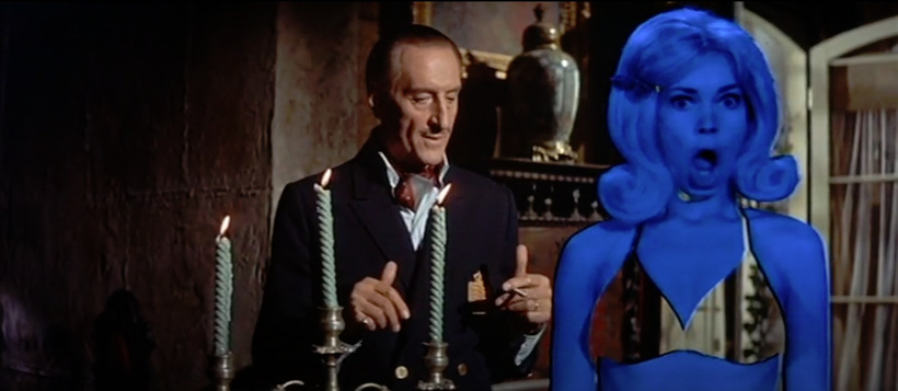 Well. Let's see. A creepy dude, a candalabra, and a blue woman with what looks like a green screen bikini, which seems to be reflecting inside the house? I am guessing here. I once again have not seen the movie.