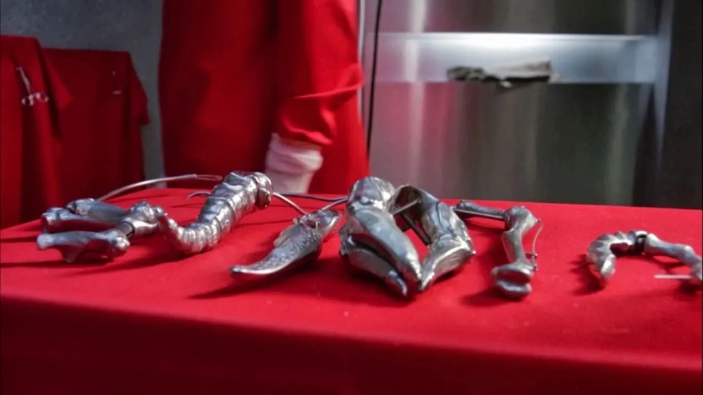 A red-draped table with bizarre surgical tools on it. When I say bizarre, I mean  Hellraiser-level strange.